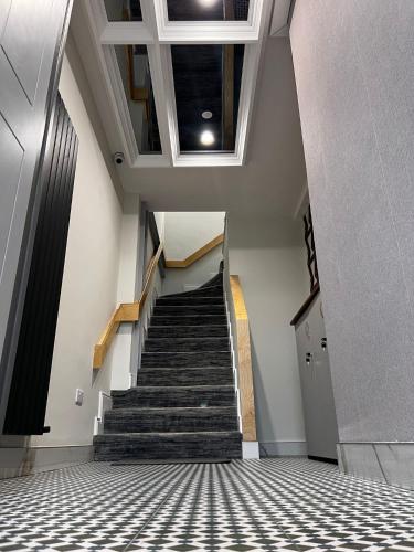 a staircase in a building with a tile floor at 53 Luxury Accommodation in Maynooth