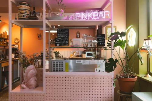 a pink kitchen with a counter in a room at Hostel Ani&Haakien in Rotterdam