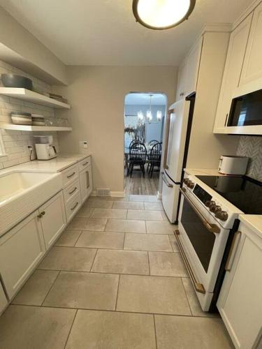 a kitchen with a refrigerator and a stove top oven at The Warm & Inviting Place in Sioux Falls