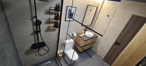 La petite salle de bains est pourvue de toilettes et d'un miroir. dans l'établissement JK Luxury Old Town Apartment, à Thessalonique