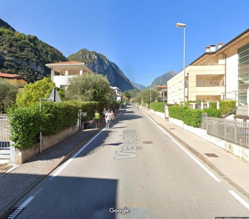 a street with people walking down the street at L Ora del Garda in Riva del Garda