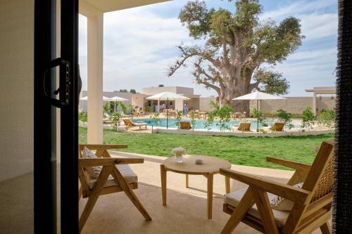 a view of the pool from the patio of a house at Kawga Hôtel in Ngaring