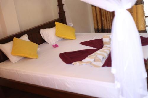a bed with colorful pillows and towels on it at Mirissa Jungle view in Mirissa