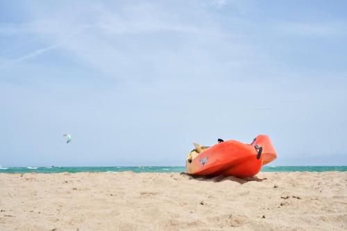 a person laying in the sand on the beach at Glamping Costa Brava in Fortiá