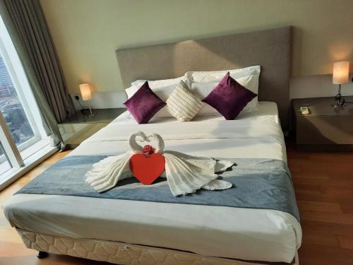 a bedroom with a bed with a heart and angel wings at Platinum KLCC by Luxury Suites in Kuala Lumpur
