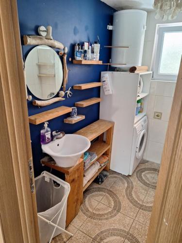 a small bathroom with a sink and a refrigerator at SunnyDay House in Masline
