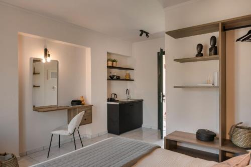 a bedroom with a bed and a sink and a mirror at Rosilion Studios & Apartments in Katelios