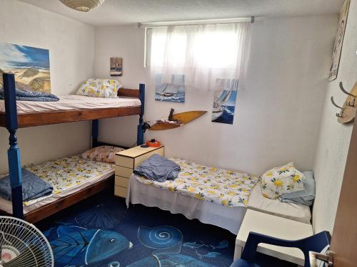 a bedroom with two bunk beds and a window at SunnyDay House in Masline