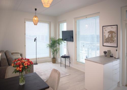 a living room with a couch and a table at New 3-Bed Apartment & Free Garage parking in Vantaa