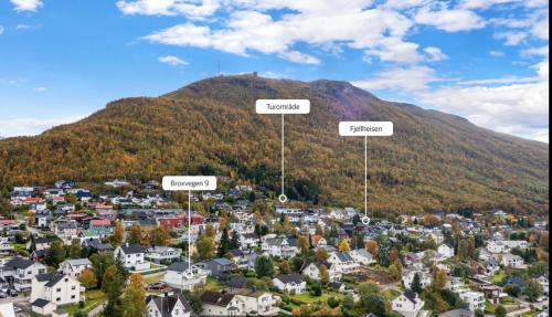 a small town in front of a mountain at 1 roms leilighet sentralt in Tromsø