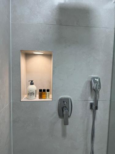 a shower with a faucet in a bathroom at Апартаменти в центрі Тернополя in Ternopil