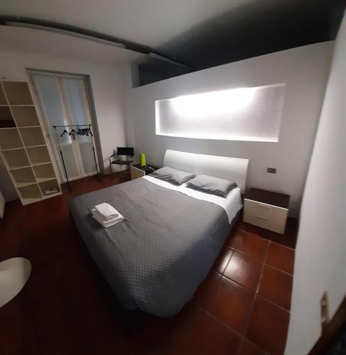 a bedroom with a large bed and a window at Volta 8 in Cassano Magnago