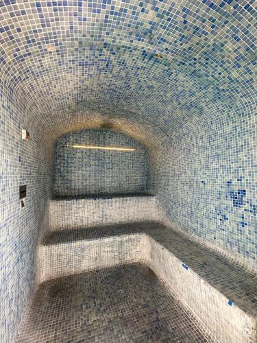 a bathroom with a tiled wall and stairs in it at Turia Granada in Granada