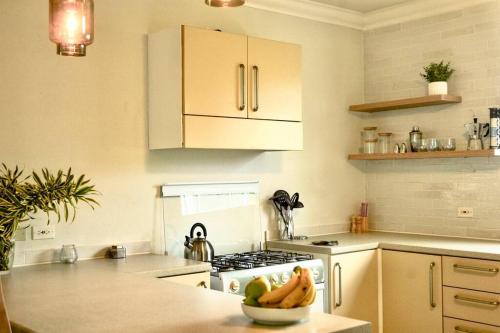 a kitchen with a bowl of fruit on a counter at Freight’s Reach #6 Cotton Bay in Christ Church