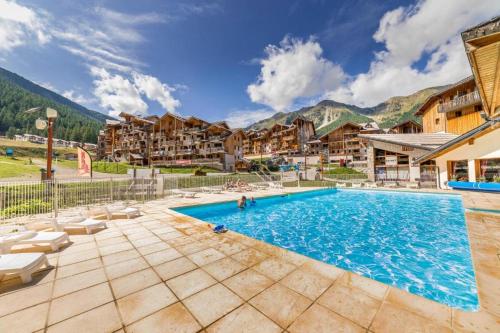 a resort swimming pool with mountains in the background at Les Orres 1800 - 6 places Plein Sud avec Piscine in Les Orres