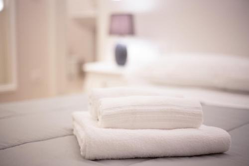 a stack of white towels sitting on a bathroom counter at Ca Viola e Tobia by Venicevillas in Venice