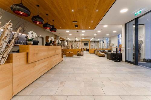 a lobby of a store with a hair salon at PLAZA INN Dachau - München in Dachau