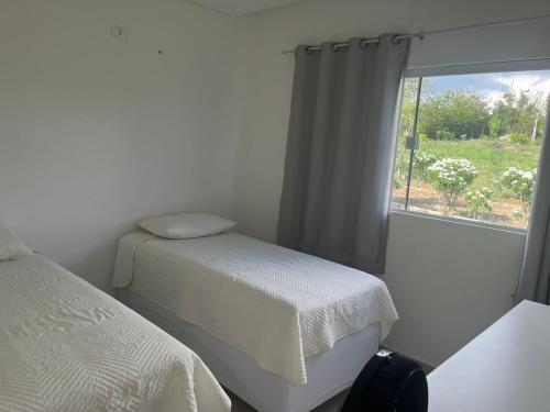 Ένα ή περισσότερα κρεβάτια σε δωμάτιο στο Condomínio Villa Verde Triunfo