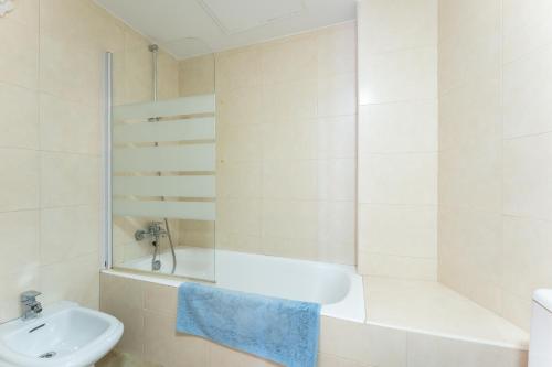 a bathroom with a tub and a sink and a toilet at Sierra Mar Penthouse in Mijas