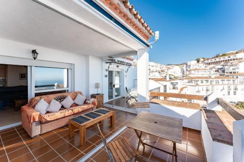 a living room with a couch and a table at Sierra Mar Penthouse in Mijas