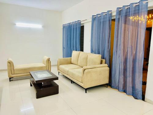 a living room with a couch and a coffee table at 2BHK Oasis in Prime Kharadi in Pune