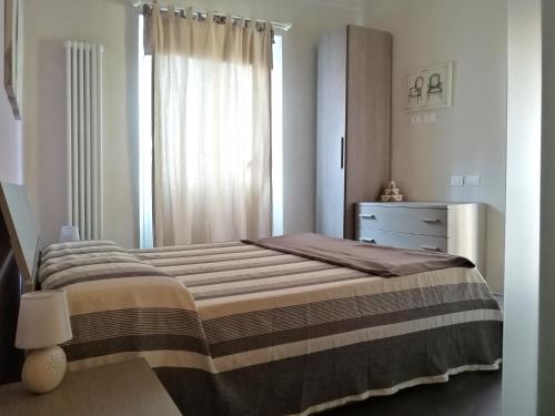 een slaapkamer met een bed, een dressoir en een raam bij FM Lake in Como