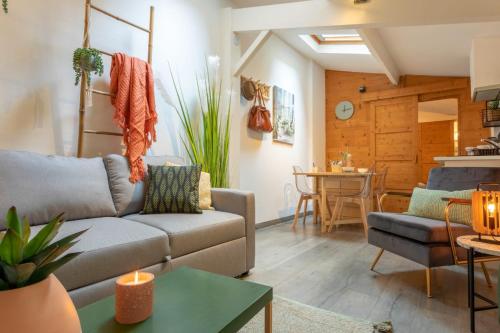 un salon avec un canapé et une table dans l'établissement Chartreuse, clim, parking, terrasse au calme, à Toulouse