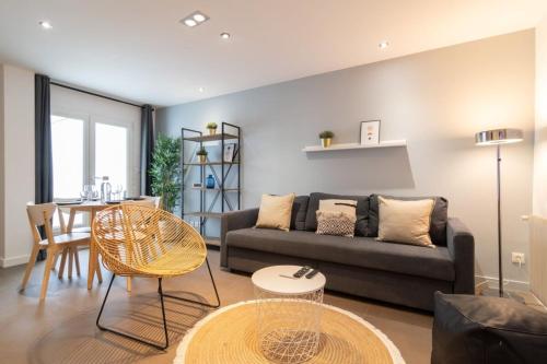 ein Wohnzimmer mit einem Sofa und einem Tisch in der Unterkunft Tourcoing equipped apartment with terrace in Tourcoing