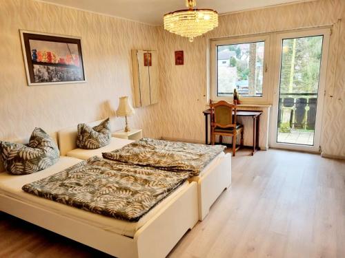 GadernheimにあるRELAX WOHNUNG LAUTERTALのベッドルーム1室(ベッド1台、ソファ、テーブル付)