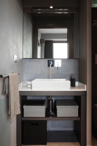 a bathroom with a sink and a mirror at Arborina Relais in La Morra