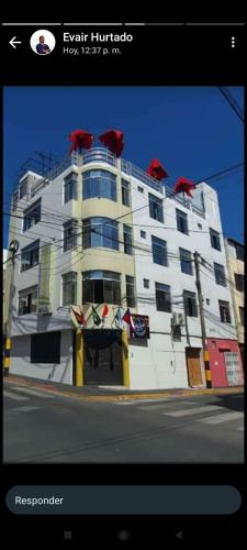 un gran edificio blanco con cúpulas rojas encima en Real Victoria, en Ilo