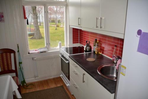 a small kitchen with a sink and a window at Angelas Fjord Suite in Stamsund