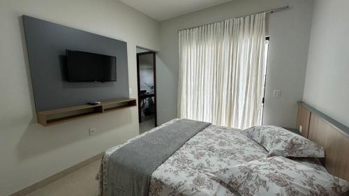 1 dormitorio con 1 cama y TV de pantalla plana en Casa Alissa en Bonito
