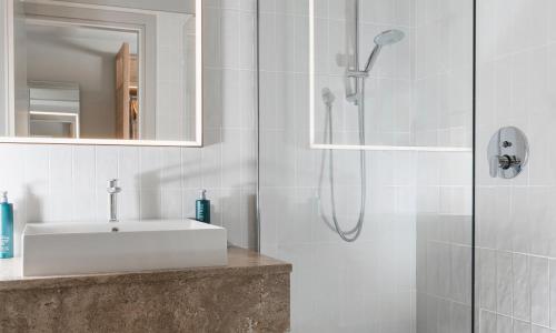 a bathroom with a sink and a shower at Hilton Garden Inn Bologna North in Bologna