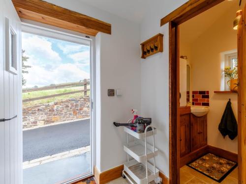 a door leading into a room with a window at 2 Bed in Bishops Tawton 79393 in Bishops Tawton