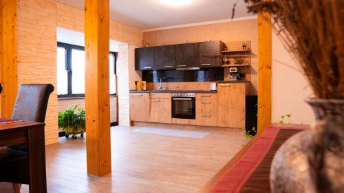 a large kitchen with wooden cabinets and appliances at may-homestay-saar in Neunkirchen