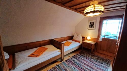 a small bedroom with two beds and a window at Ferienhütte Panoramablick 
