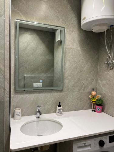 a bathroom with a sink and a mirror at Port View Apartment 2 in Durrës