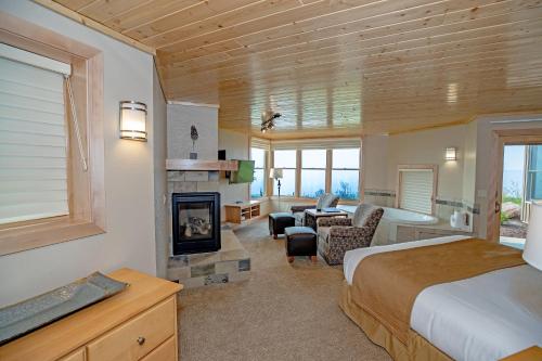 a bedroom with a bed and a living room with a fireplace at Surfside on Lake Superior in Tofte