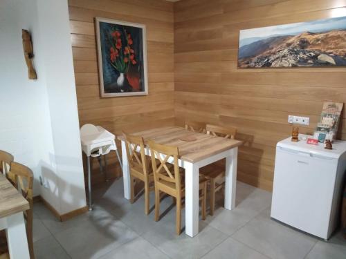 a kitchen with a table and chairs in a room at Noclegi Ostoja Gromadzyń in Ustrzyki Dolne