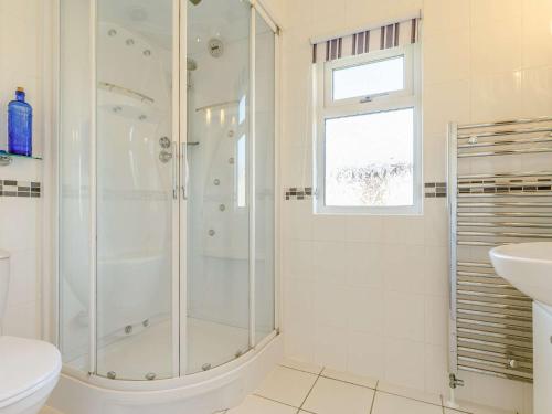 a white bathroom with a shower and a sink at 3 Bed in Millbrook 83792 in Millbrook