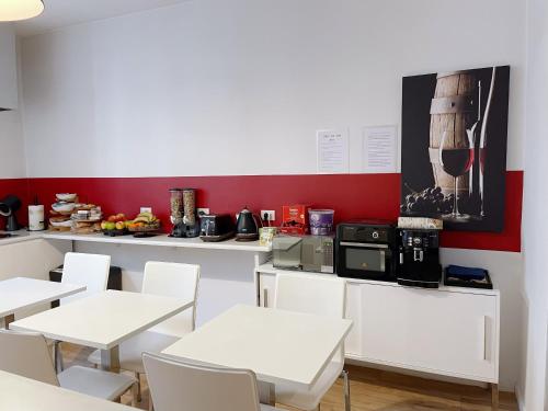 a dining room with white tables and white chairs at CASA IVH BNB in Florence