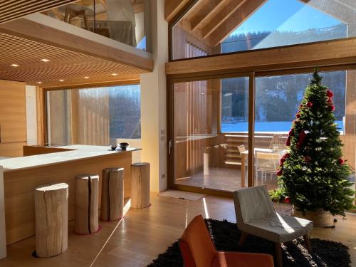 a living room with a christmas tree in the center at Luxury Chalet in the Tarvisio mountains in Camporosso in Valcanale