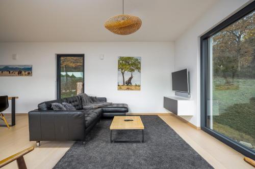 a living room with a couch and a table at Villa calme avec vue 4 à 8 personnes - salle de sport in Saint-Amarin