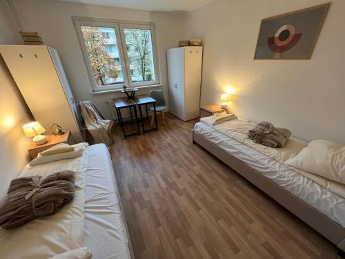 a room with two beds and a window at Unterkunft für bis zu 5 Personen in Spremberg in Spremberg