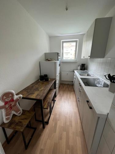 a small kitchen with a table and a refrigerator at Unterkunft für bis zu 5 Personen in Spremberg in Spremberg
