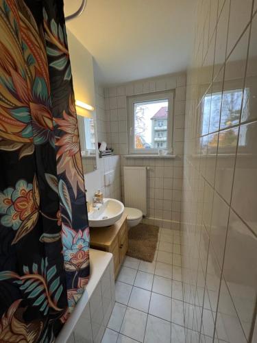 a bathroom with a sink and a shower curtain at Unterkunft für bis zu 5 Personen in Spremberg in Spremberg