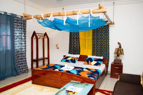 a bedroom with a bed with a canopy at Villa Le Désir RKDS in Grand-Popo