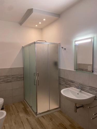 a bathroom with a glass shower and a sink at Castello di Sabbia in Trabia