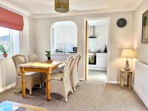 a dining room with a wooden table and chairs at Fewster Apartment - City Centre location with free parking in York